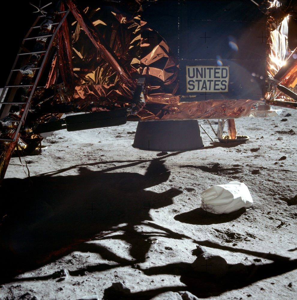 The three-foot long "Jett bag" kicked out of view underneath the lunar module. Note the nozzle of the engine from the descent stage (this part is still on the moon today).
