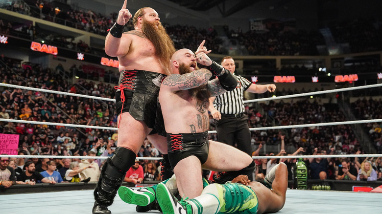 Erik and Ivar pose over a fallen Kofi Kingston after a win on "WWE Raw."