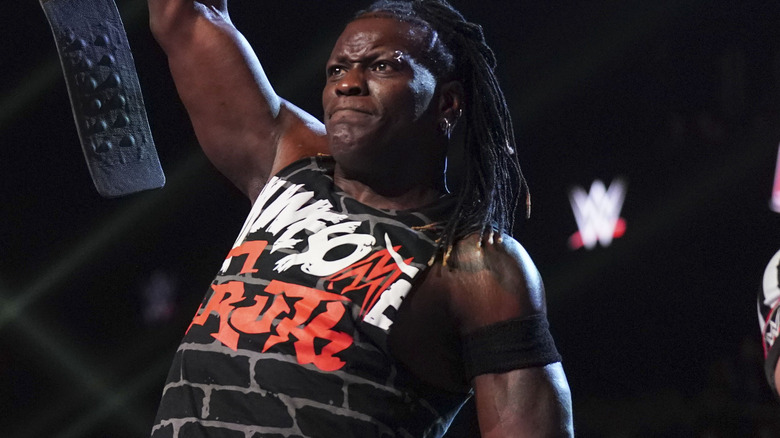 R-Truth holding up his tag team title belt on "WWE Raw,"